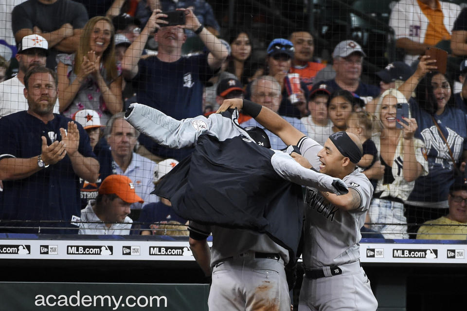 New York Yankees' Rougned Odor, right, puts a jacket on Gary Sanchez after Sanchez's three-run home run during the eighth inning of a baseball game against the Houston Astros, Sunday, July 11, 2021, in Houston. (AP Photo/Eric Christian Smith)