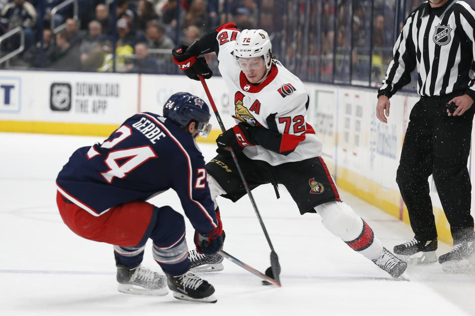 Ottawa Senators' Thomas Chabot (72) carries the puck across the blue line as Columbus Blue Jackets' Nathan Gerbe, left, defends during the first period of an NHL hockey game Monday, Feb. 24, 2020, in Columbus, Ohio. (AP Photo/Jay LaPrete)