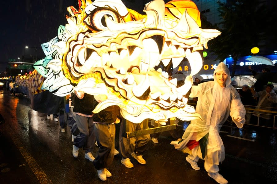 Buddhists walk with a giant lantern in the share of a dragon during the Lotus Lantern Festival, ahead of the birthday of Buddha at Dongguk University in Seoul, South Korea, Saturday, May 11, 2024. (AP Photo/Ahn Young-joon)