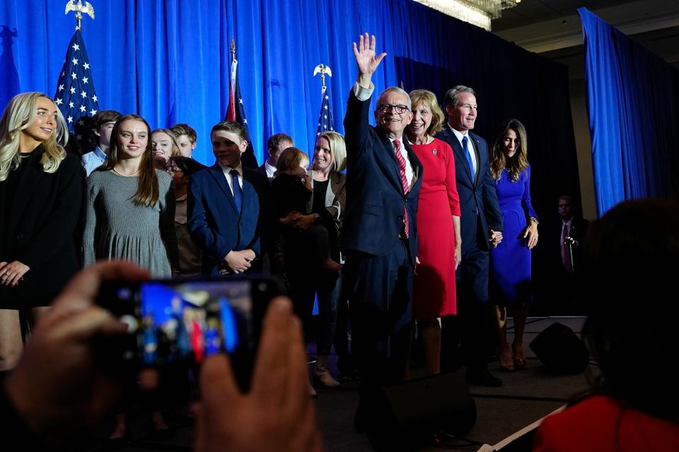 After being re-elected, Gov. Mike DeWine waves to supporters during an election night party for Republican candidates,