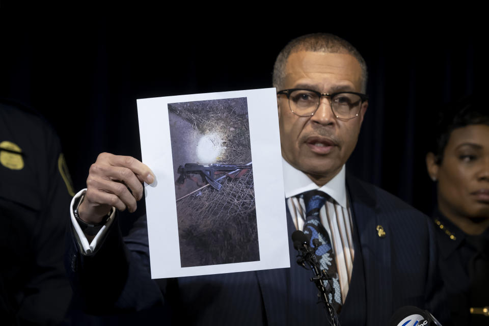 Detroit Police Chief James Craig shows a photograph of an "assault-type weapon" used by the suspect as he speaks to the media at Detroit Public Safety Headquarters Thursday, November 21, 2019, about two officers who were shot Wednesday evening while responding to a home invasion on Detroit's west side. Officer Rasheen McLain was killed during the incident and another officer was wounded. (David Guralnick/Detroit News via AP)