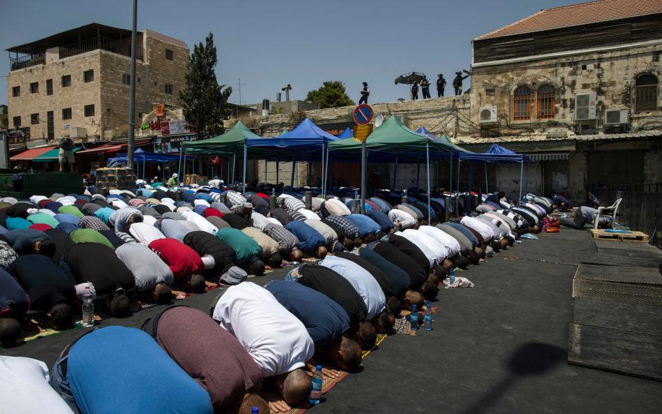 Thousands of Palestinians prayed in the streets - Credit: AP Photo/Tsafrir Abayov