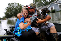<p>David Gonzalez comforts his wife Kathy after being rescued from their home flooded by Tropical Storm Harvey in Orange, Texas, Aug. 30, 2017. (Photo: Jonathan Bachman/Reuters) </p>