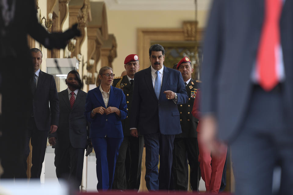 Venezuela's President Nicolas Maduro arrives for a press conference at the Miraflores Presidential Palace in Caracas, Venezuela, Thursday, March 12, 2020. Maduro has suspended flights to Europe and Colombia for a month, citing concerns for the new coronavirus. Maduro added in a national broadcast that the illness has not yet been detected in Venezuela, despite it being confirmed in each bordering country, including Colombia, Brazil and Guyana. (AP Photo/Matias Delacroix)