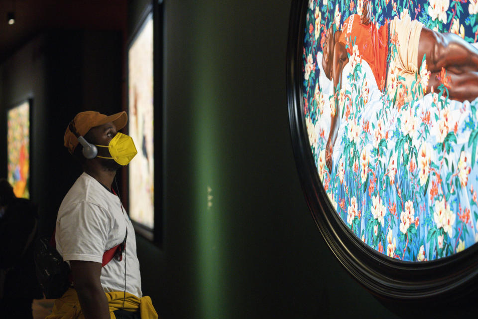 Fenyang Smith looks at a painting by Kehinde Wiley titled "Sleep," at the de Young Museum in San Francisco, Friday, March 24, 2023. The painting is part of the "Kehinde Wiley: An Archaeology of Silence," exhibition. (AP Photo/Godofredo A. Vásquez)