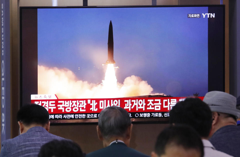 People watch a TV showing a file image of North Korea's missile launch during a news program at the Seoul Railway Station in Seoul, South Korea, Wednesday, July 31, 2019. North Korea on Wednesday fired several unidentified projectiles off its east coast, South Korea's military said, less than a week after the North launched two short-range ballistic missiles into the sea in a defiance of U.N. resolutions. The signs read: "North Korea's missile is a bit different from the past." (AP Photo/Ahn Young-joon)