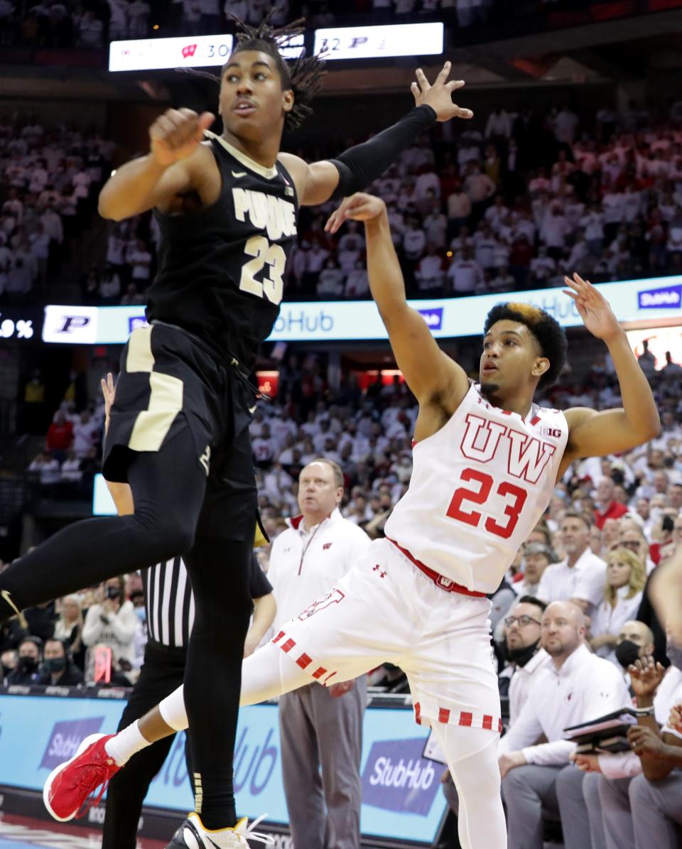 Wisconsin guard Chucky Hepburn (23) watches his three-point basket while being defended by Purdue guard Jaden Ivey (23) during the closing seconds of their game Tuesday, March 1, 2022 at the Kohl Center in Madison, Wis. Wisconsin beat Purdue 70-67 to win the Big Ten Championship.
