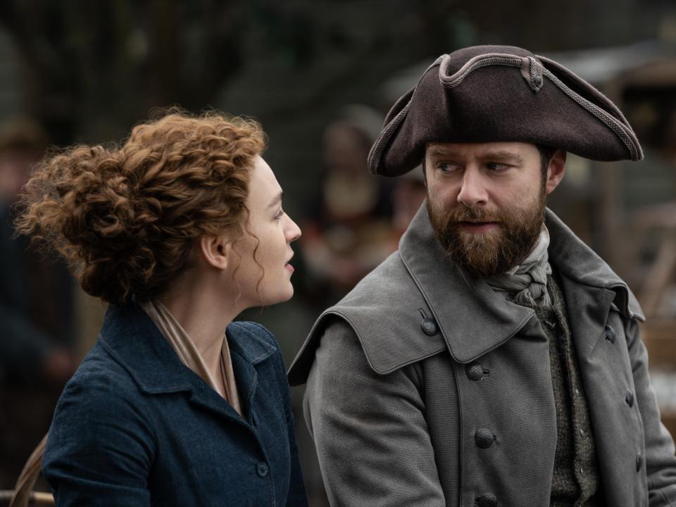 Sophie Skelton as Brianna MacKenzie and Richard Rankin as Roger MacKenzie in "Outlander" season seven, episode two.