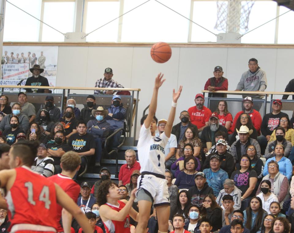 Navajo Prep's Xavier Nez (1) puts up a 3-point shot against Cobre in the first quarter of an NMAA state tournament game Saturday, March 4, 2023 at the Eagles Nest.