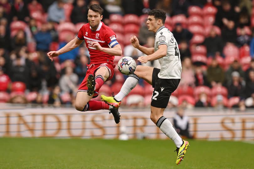 Jonny Howson of Middlesbrough competes with Bailey-Tye Cadamarteri of Sheffield Wednesday