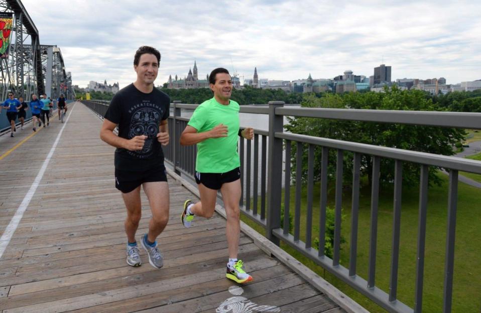 Prime Minister Justin Trudeau and Mexican President Enrique Pena Nieto run across the Alexandra Bridge from Ottawa to Gatineau, Quebec on Tuesday, June 28, 2016. THE CANADIAN PRESS/Sean Kilpatrick