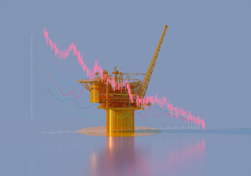 Digital generated image of yellow semi transparent offshore oil rig and falling oil prices chart on pastel blue background. Photo: Getty