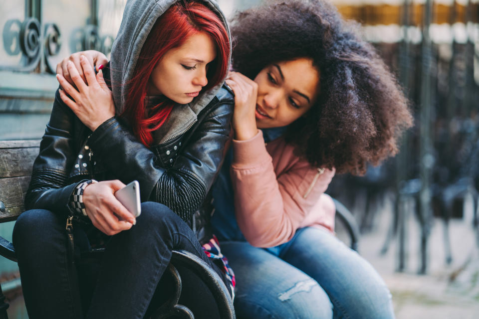 Teenage girl supporting friend