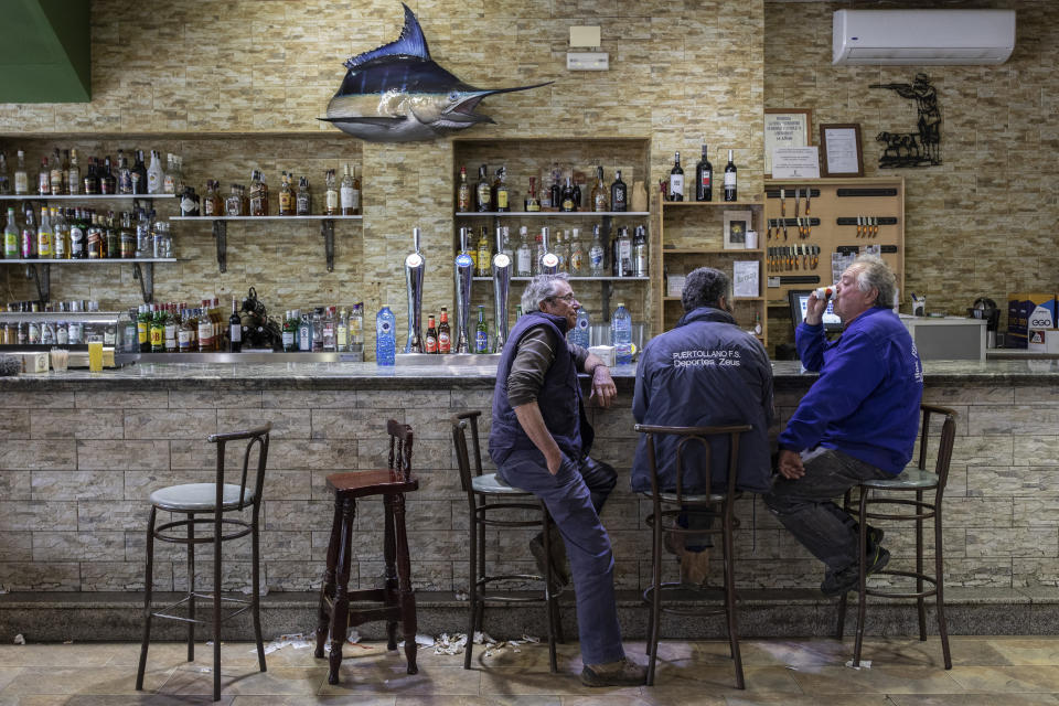 In this April 10, 2019 photo, villagers gather at a bar in Brazatortas, on the edge of the Alcudia valley, central Spain. With nearly 400,000 voters in a country of 37 million, Ciudad Real is a microcosm of the weight of rural areas in national politics. In the last general election, in 2016, three of the five deputies chosen by the province went to the PP conservatives and two to the Socialists. But reflecting the crisis of bipartisan politics, polls are predicting now at least two seats for the Socialists and one for PP, with the remaining two going for a few thousand votes of difference to either two of the once-dominant parties, or even a split between the center-right Citizens and Vox. (AP Photo/Bernat Armangue)