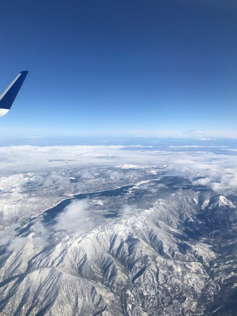 This photo provided by Greg Weber shows a snows covered Big Bear Lake in Big Bear, Calif., on Friday, Dec. 27, 2019. A winter storm has brought a deluge of rain and snow to Southern California. Snow has shut down the vital Interstate 5 in Tejon Pass through the mountains north of Los Angeles and dozens of miles of Interstate 15 from Baker, California, to Primm, Nevada. (Greg Weber via AP)