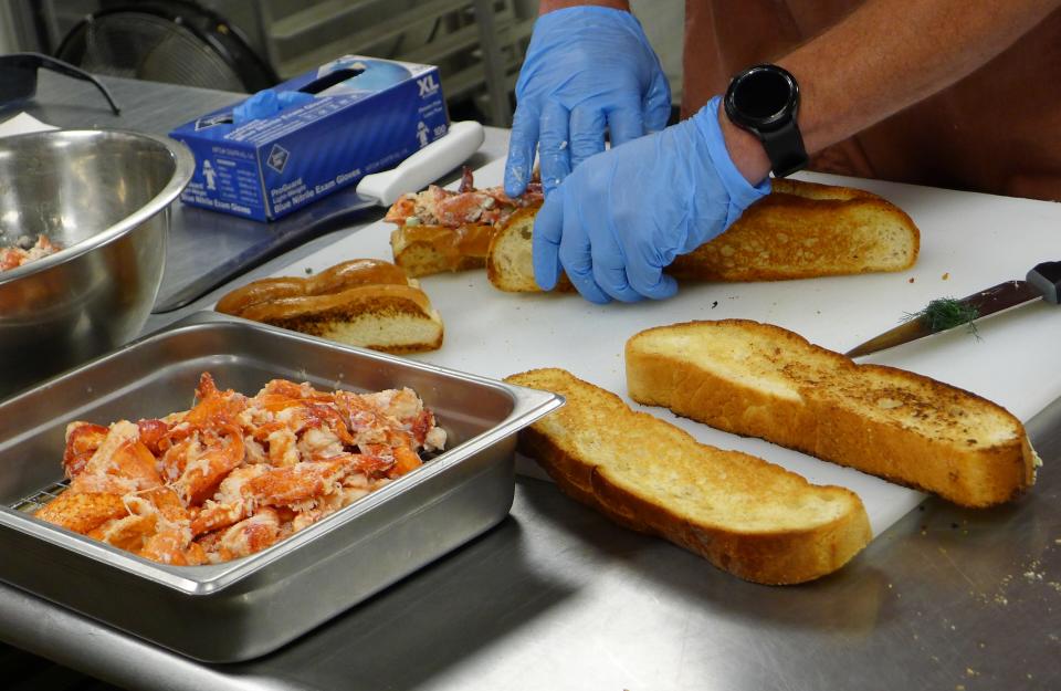 Chef Heith Sheeley composes the footlong lobster roll at JR's SouthPork Ranch at the Iowa State Fair.