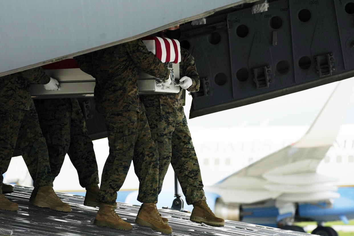 FILE - A carry team moves a transfer case containing the remains of Marine Corps Staff Sgt. Darin T. Hoover, 31, of Salt Lake City, on Aug. 29, 2021, at Dover Air Force Base, Del. According to the Department of Defense, Hoover died in an attack at Afghanistan's Kabul airport, along with 12 other U.S. service members. The Taliban have killed the senior Islamic State group leader behind the August 2021 bombing outside the Kabul airport that killed 13 service members and about 170 Afghans. That is according to the father of a Marine killed in the attack who was briefed on April 25, 2023, by military officials. (AP Photo/Carolyn Kaster, File)