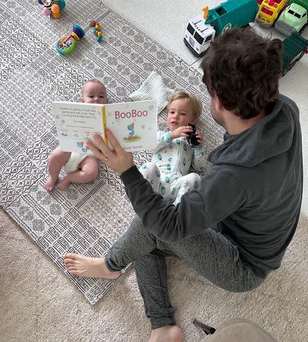 <p>mandy moore/Instagram</p> Taylor Goldsmith reading to his sons