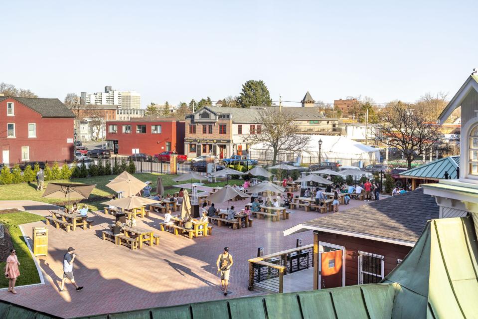 Customers enjoy sunny weather and cold beers at the Saranac Biergarten.