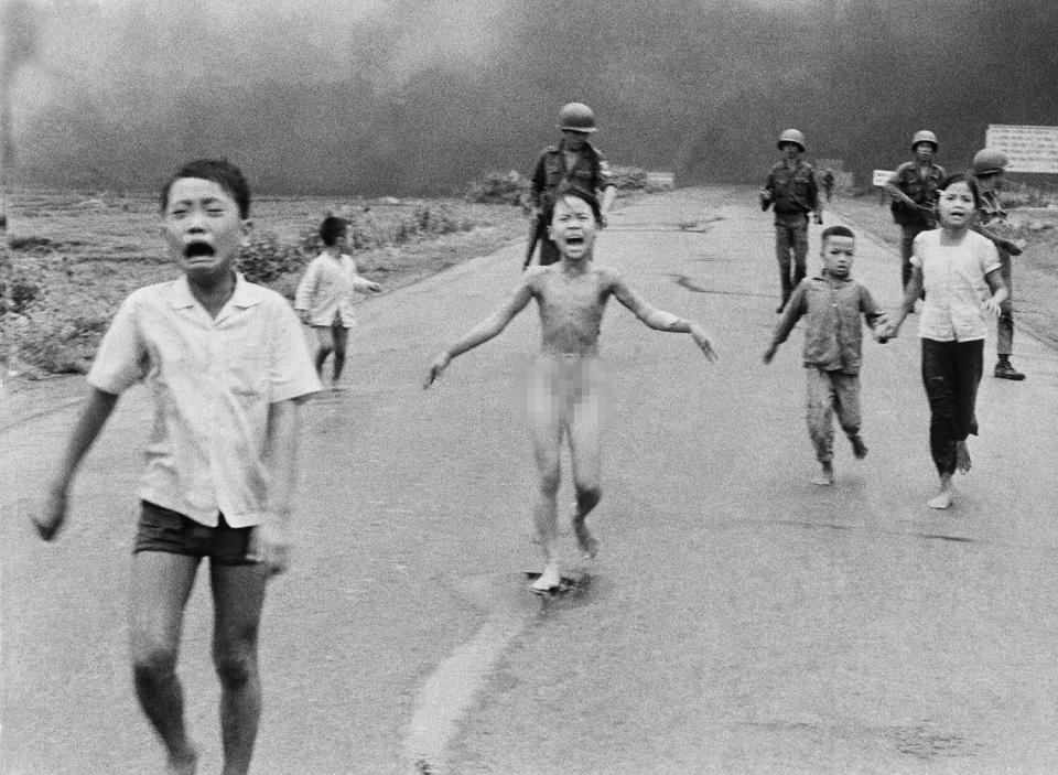Mandatory Credit: Photo by Nick Ut/AP/Shutterstock (7364170a) South Vietnamese forces follow after terrified children, including 9-year-old Kim Phuc, center, as they run down Route 1 near Trang Bang after an aerial napalm attack on suspected Viet Cong hiding places on . A South Vietnamese plane accidentally dropped its flaming napalm on South Vietnamese troops and civilians. The terrified girl had ripped off her burning clothes while fleeing. The children from left to right are: Phan Thanh Tam, younger brother of Kim Phuc, who lost an eye, Phan Thanh Phouc, youngest brother of Kim Phuc, Kim Phuc, and Kim's cousins Ho Van Bon, and Ho Thi Ting. Behind them are soldiers of the Vietnam Army 25th Division Napalm Girl, Trang Bang, Vietnam