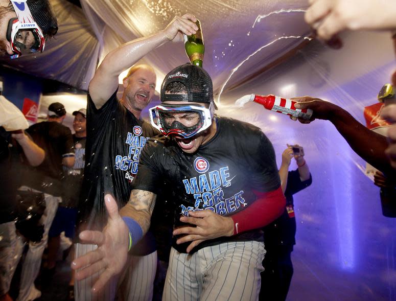 Cubs' catcher David Ross douses Javier Baez with champagne during the Cubs NL Central celebration. (AP)