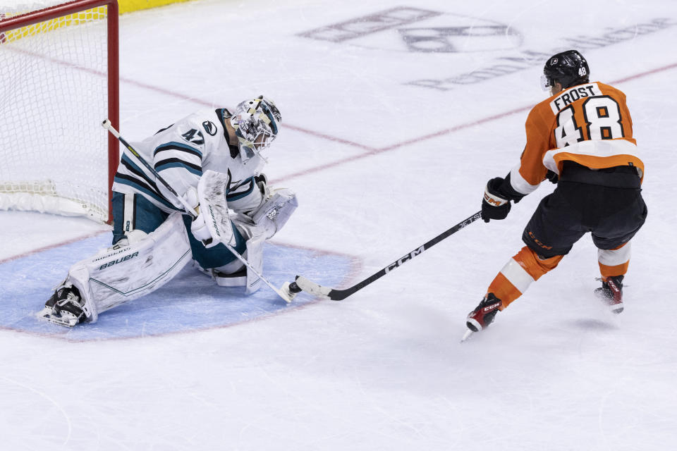 San Jose Sharks goaltender James Reimer (47) stops an attempt on goal by Philadelphia Flyers center Morgan Frost (48) during the third period of an NHL hockey game, Sunday, Oct. 23, 2022, in Philadelphia. (AP Photo/Laurence Kesterson)