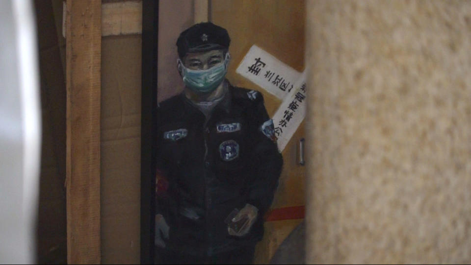 A painting by Zeng Fanzhi, a retired architect turned artist, depicting residents locked inside their home during the COVID lockdown, is tucked away after censors deem it "too negative" during the Beijing art exposition in Beijing, Friday, Sept. 8, 2023. Zeng painted stark, realist portrayals of life in China under zero-COVID, saying he did so to capture a unique moment in history. (AP Photo/Dake Kang)