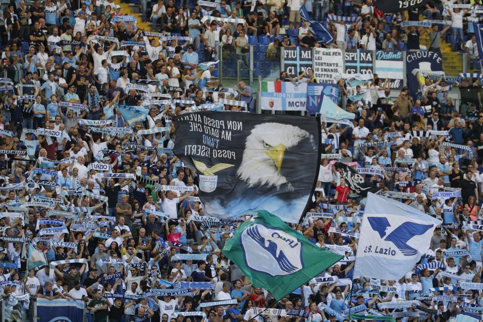 Lazio fans cheer during a Serie A soccer match between Lazio and Genoa, at the Rome Olympic Stadium, Sunday, Sept. 29, 2019. (AP Photo/Andrew Medichini)