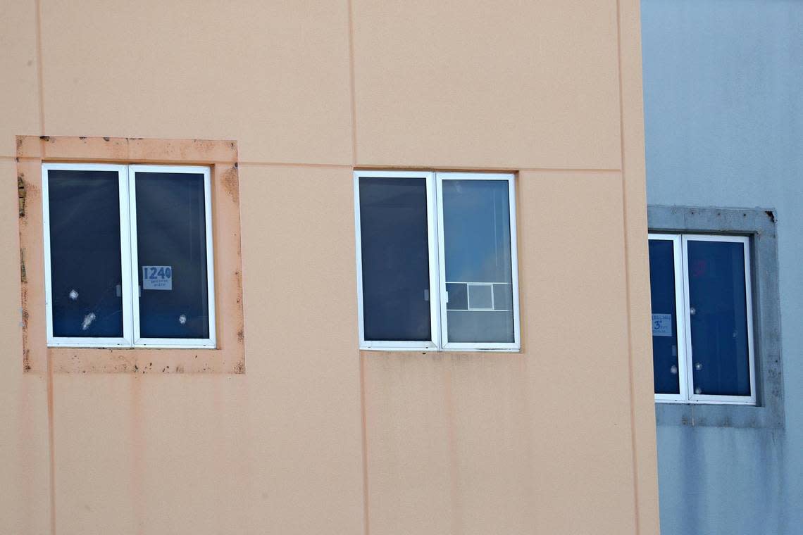 A sign reading ’1240 west facing window’ and five bullet holes can be seen in a third-floor window of the 1200 building at Marjory Stoneman Douglas High School in Parkland on Aug. 4, 2022. The freshman building is where 17 students and faculty members were shot to death on Feb. 14, 2018.