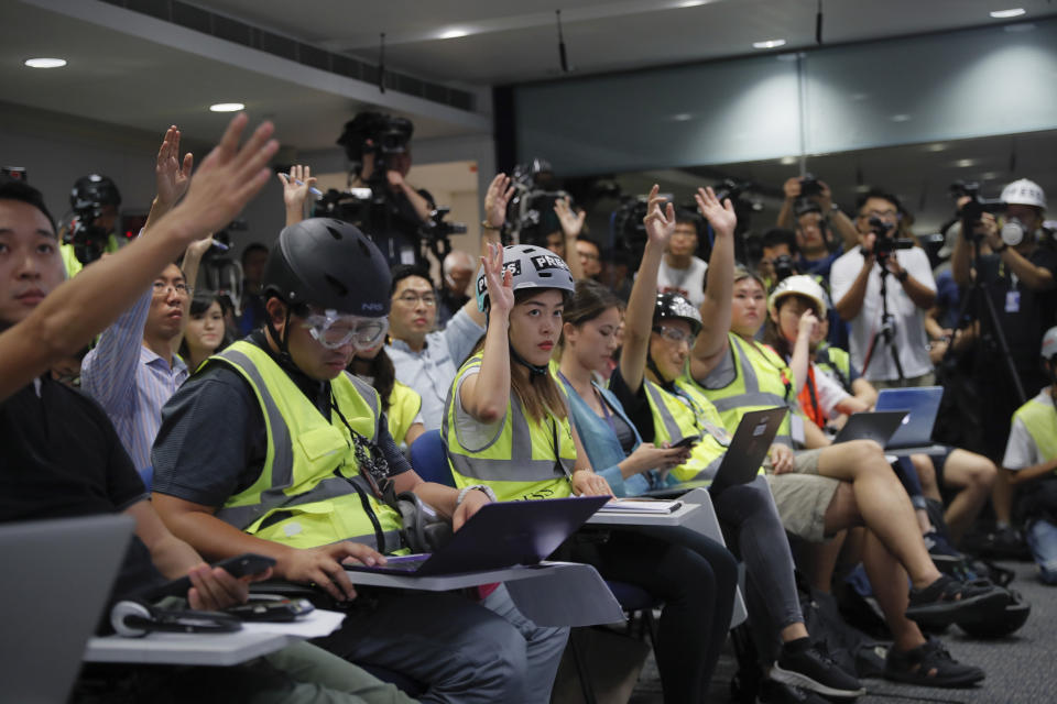 In a sign of protest against the police using force against the media, journalists wear protective gear during a police media conference in Hong Kong, Monday, Sept. 9, 2019. Hong Kong's government agreed last week to withdraw an extradition bill that sparked a summer of protests, but demonstrators want other demands to be met, including direct elections of city leaders and an independent inquiry into police actions. (AP Photo/Kin Cheung)