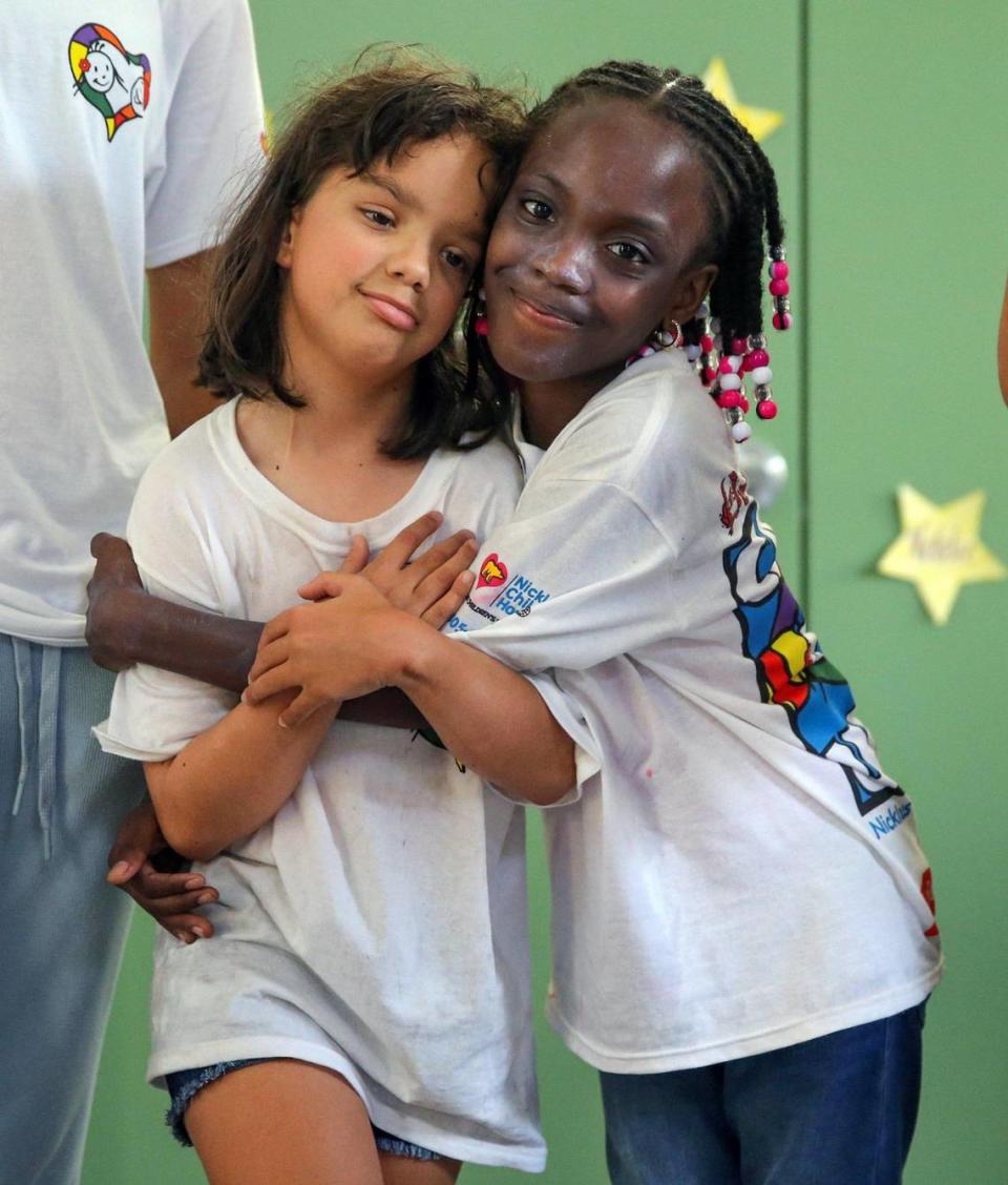 Gia, left, and Phaedra hug at Camp U.O.T.S. on July 23.