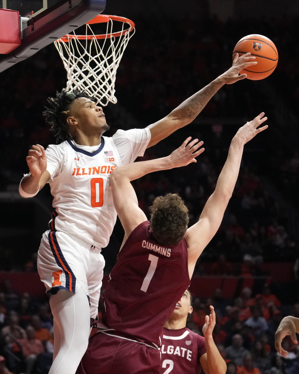 Illinois' Terrence Shannon Jr. (0) blocks the shot of Colgate's Brady Cummins during the second half of an NCAA college basketball game Sunday, Dec. 17, 2023, in Champaign, Ill. Illinois won 74-57. (AP Photo/Charles Rex Arbogast)