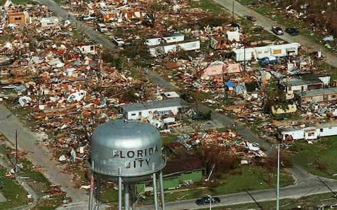 A water tower stands over the ruins of the coastal community of Florida City.