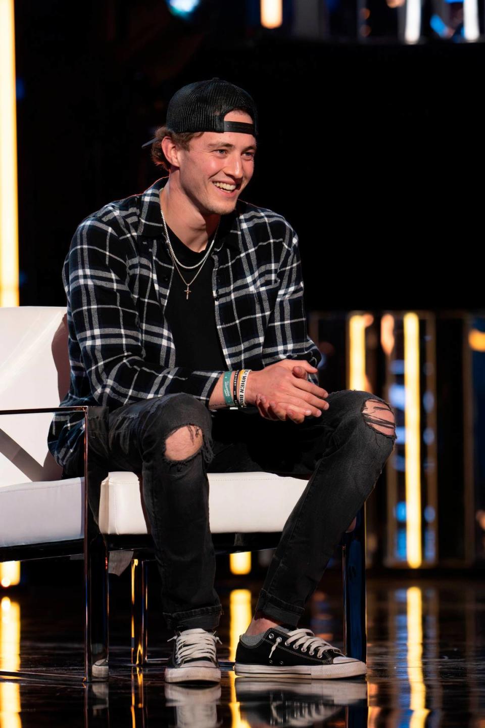 Blake sits in front of the judges to hear their decision.