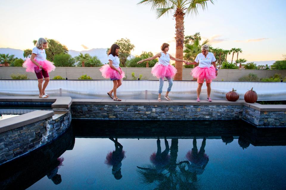 The Mixed Housewives of Del Webb, a group of women in the Del Webb neighborhood, find a spot for posing in their pink tutus in Rancho Mirage, Calif., on Tuesday, October 4, 2022. The group fundraises for the Desert Cancer Foundation and plan to participate in the 16th Annual Paint El Paseo Pink breast cancer awareness walk. 