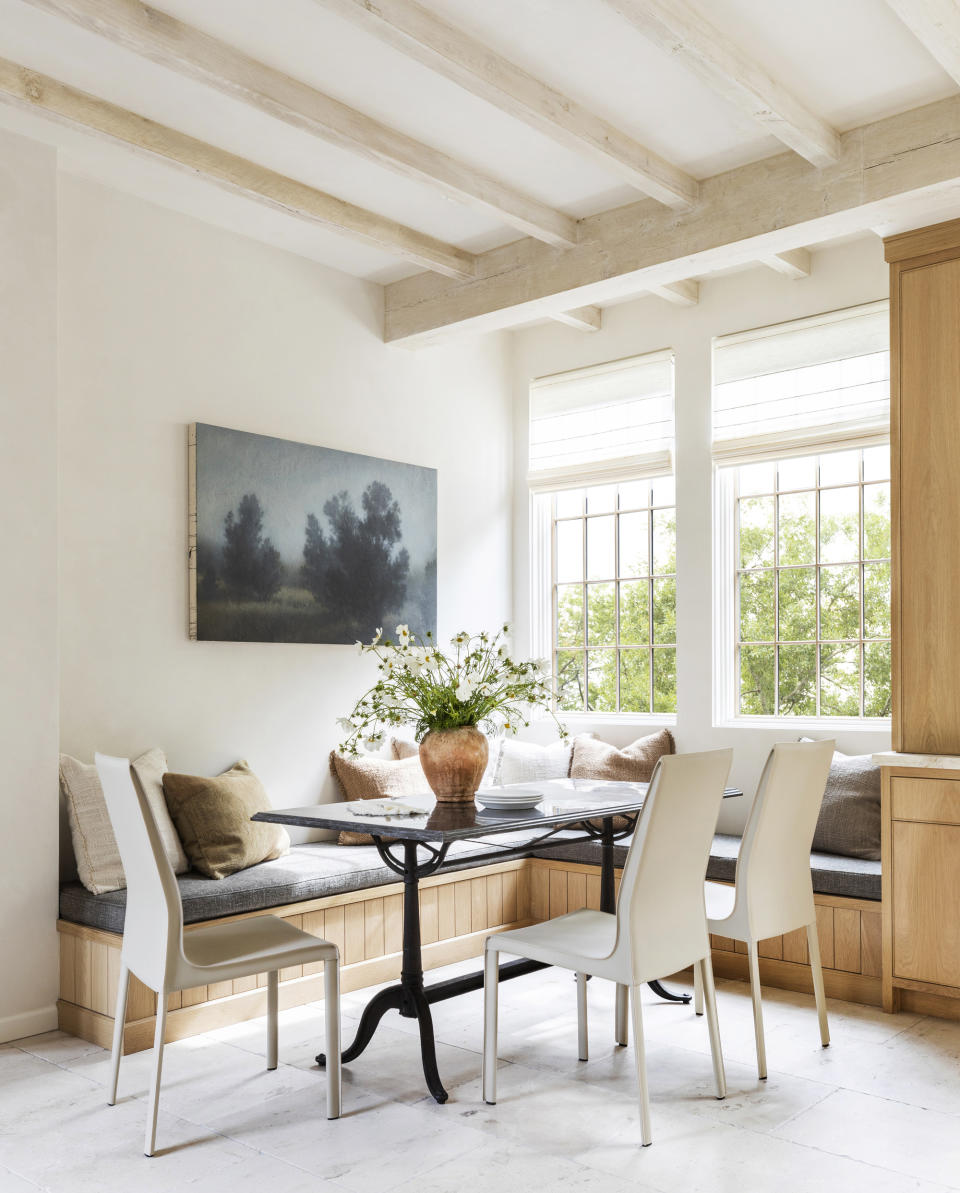 Woven wooden shades bring natural light to a dining room