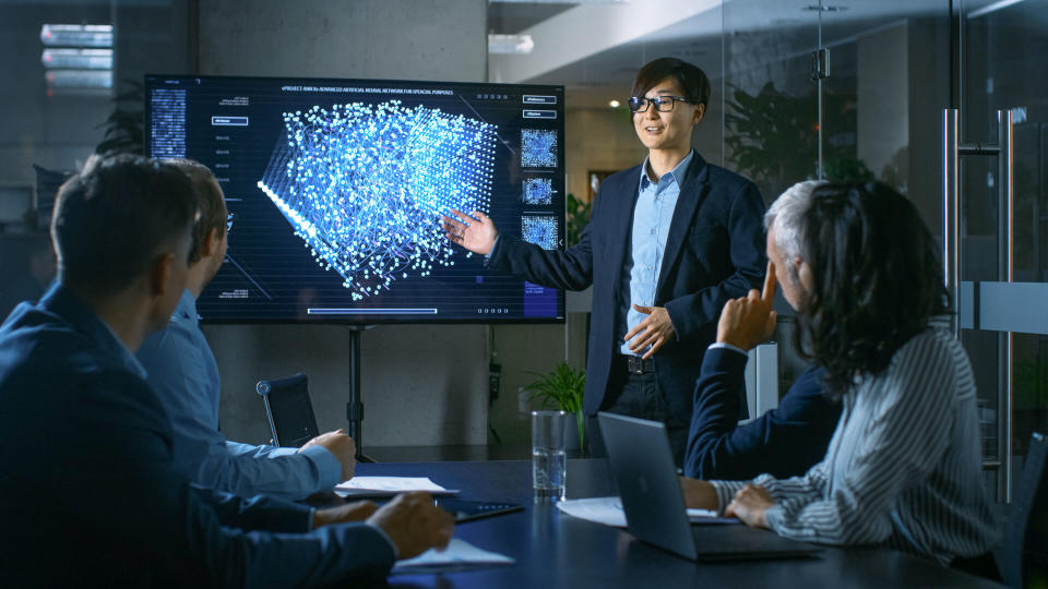 Artificial Intelligence engineer giving presentation to group of coworkers