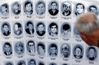 <p>A man looks at a banner with pictures of Serbs killed by Bosnian forces during the 1992-95 Bosnian war in the Srebrenica area, in downtown Belgrade, Serbia, Monday, July 10, 2017. (Photo: Amel Emric/AP) </p>