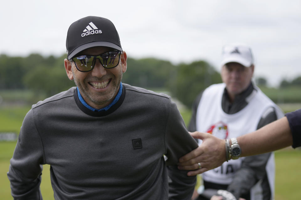 Sergio Garcia of Spain smiles as he walks off the driving range just prior to the start of the first round of the inaugural LIV Golf Invitational at the Centurion Club in St Albans, England, Thursday, June 9, 2022. (AP Photo/Alastair Grant)