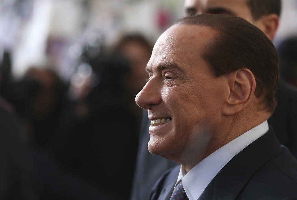 In this file photo taken Dec. 29, 2012 Silvio Berlusconi smiles as he arrives at Milan's central train station, Italy. / Credit: AP Photo/Luca Bruno, file