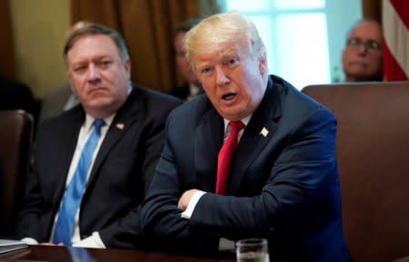 U.S. President Donald Trump addresses members of his cabinet and the news media as Secretary of State Mike Pompeo looks on during a cabinet meeting at the White House in Washington, U.S., August 16, 2018.  REUTERS/Kevin Lamarque