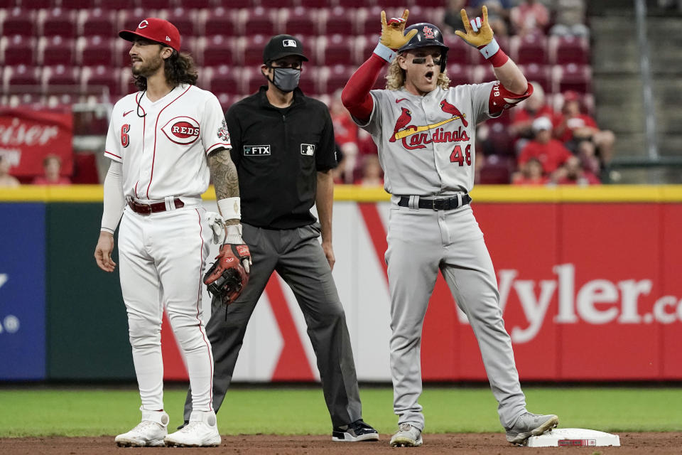 St. Louis Cardinals' Harrison Bader (48) stands next to Cincinnati Reds third baseman Jonathan India (6) at second base after hitting a double during the fifth inning of a baseball game Monday, Aug. 30, 2021, in Cincinnati. (AP Photo/Jeff Dean)