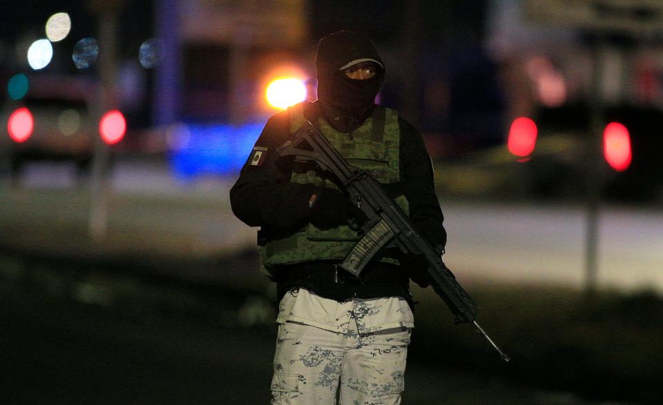 Mexican military, state, and municipal police are photographed in a residential area where five alleged hitmen were killed after police officers were ambushed in eastern Juárez on Monday night.