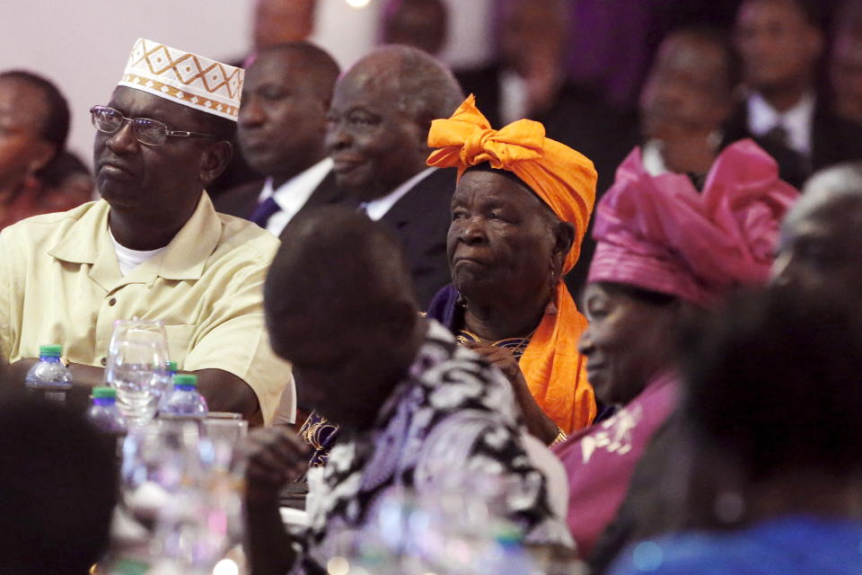 Mama Sarah Obama (C, in orange), step grandmother to U.S. President Barack Obama, and Ngina Kenyatta (R, in pink), the mother of Kenya's President Uhuru Kenyatta, look on as presidents Obama and Kenyatta deliver toasts at the end of a state dinner in Obama's honor at the State House in Nairobi July 25, 2015. Obama told African entrepreneurs in Kenya on Saturday they could help counter violent ideologies and drive growth in Africa, and said governments had to assist by ensuring the rule of law was upheld and by tackling corruption. REUTERS/Jonathan Ernst