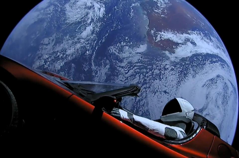 SpaceX's Starman mannequin is seen inside Elon Musk's red Tesla Roadster with Earth in the background, shortly after launch on Feb. 6, 2018. As of Nov. 2, the duo were beyond the orbit of Mars. <cite>SpaceX</cite>