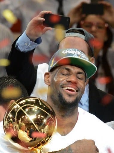 NBA Finals MVP LeBron James of the Miami Heat holds the championship trophy after defeating the Oklahoma City Thunder in Game Five of the NBA Finals in Miami, Florida. The Heat won 121-106 to capture the best-of-seven championship series four games to one