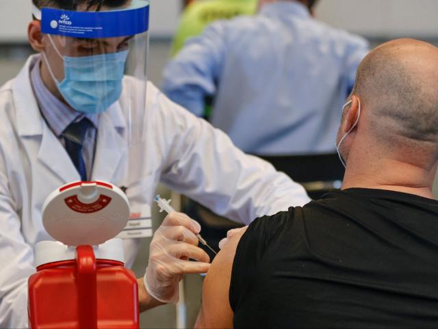 A man receives the Johnson &amp; Johnson vaccine at a vaccination site in Chicago (AFP via Getty Images)