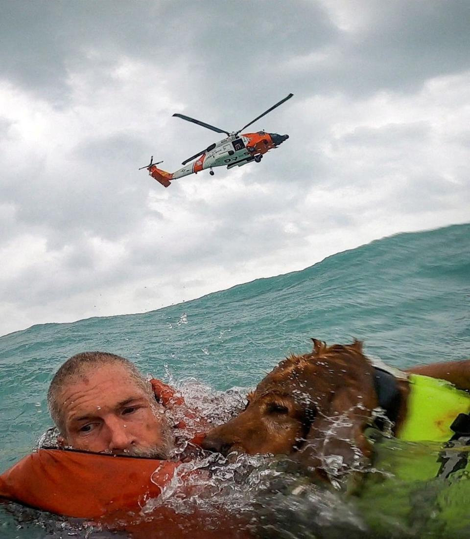 <p>A U.S. Coast Guard Air Station crew rescues a man and his dog during Hurricane Helene after his sailboat became disabled and started taking on water off Sanibel Island, Florida</p> (via REUTERS)