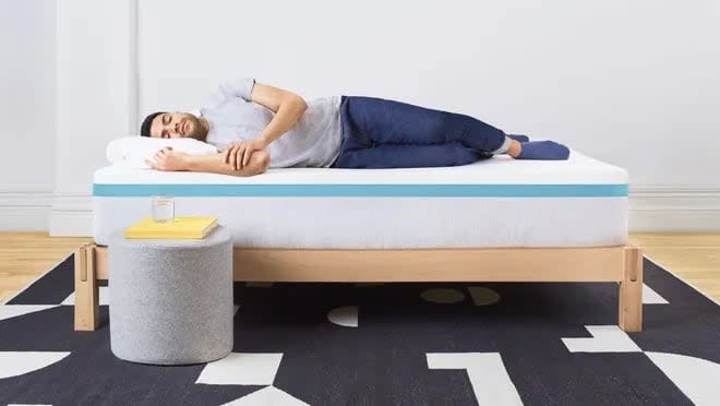 Helix mattress with a man on top in a bedroom setup.