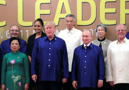 President Trump and Russian President Vladimir Putin take part in a family photo at the APEC summit in Danang, Vietnam. Sputnik/Mikhail Klimentyev/Kremlin via REUTERS
